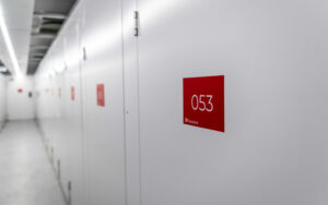 Self Storage 10 Hallway of secure self-storage units at flexistore in stellenbosch, featuring clean, white doors labeled with red unit numbers for easy identification. Ideal for organized and reliable storage solutions.